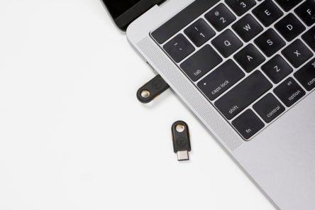 YubiKey 4C plugged into computer and another resting nearby