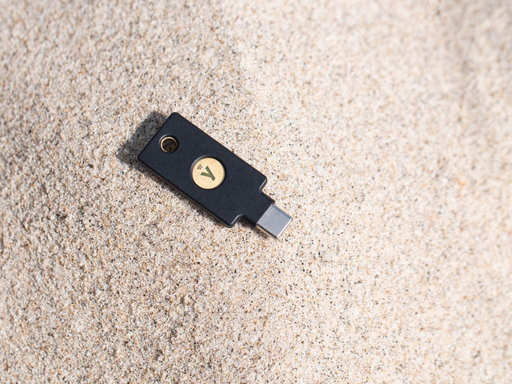 YubiKey 5C NFC on top of sand