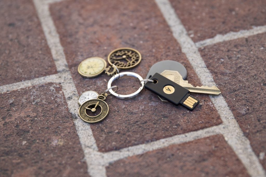 YubiKey on a key chain with various keys and decorative keychains