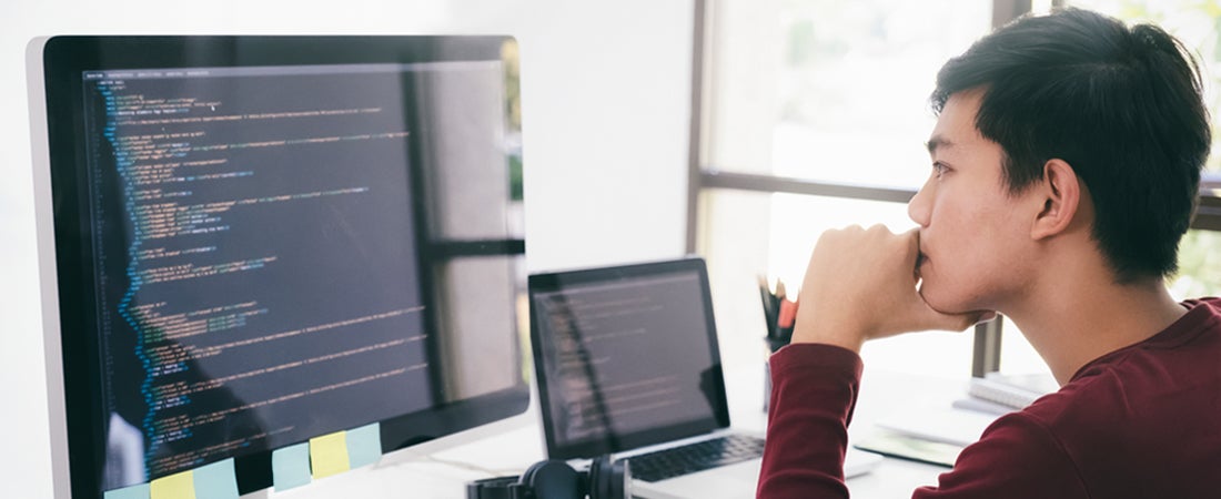 Person sitting at desk in front of computer screen