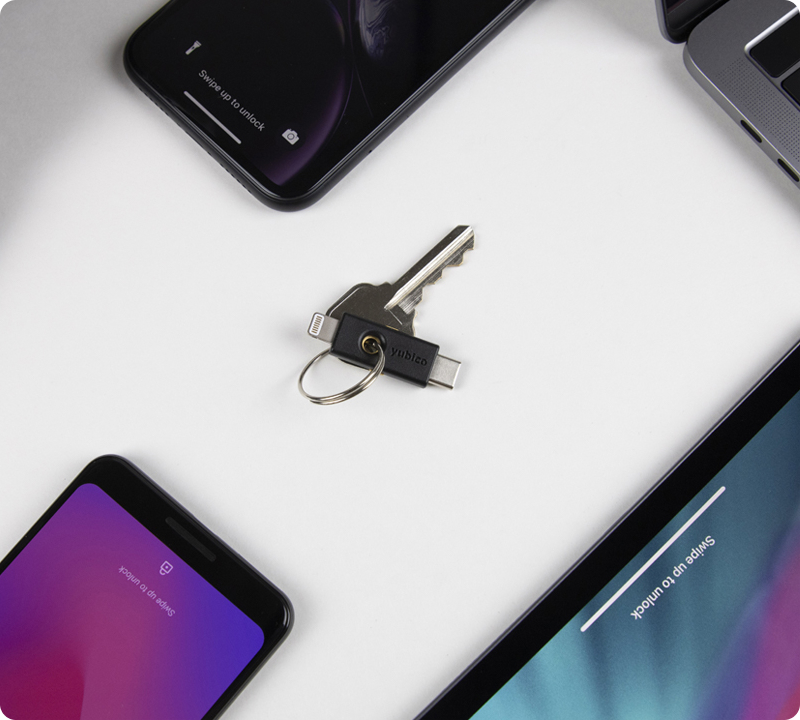 YubiKeys on chain in the middle of mobile devices