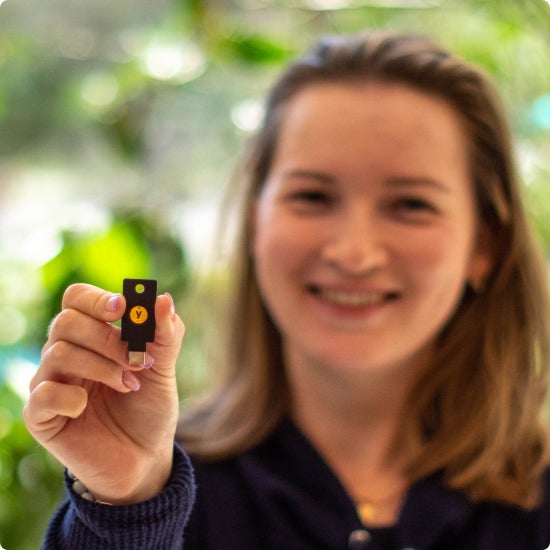 Woman holding YubiKey