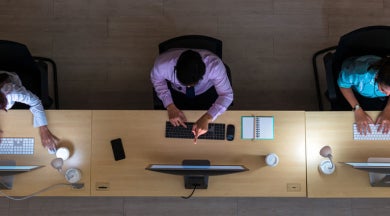 Office workers using shared workstations