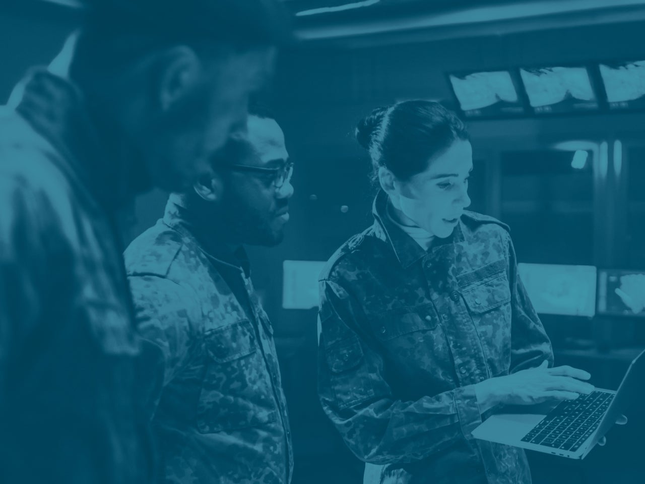military personnel looking at laptop